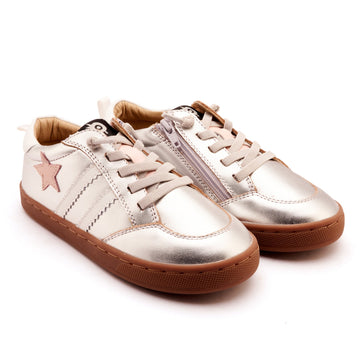 Pair of silver sneakers with brown soles on a white background