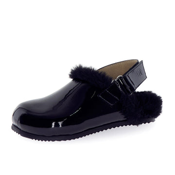 Black clog shoe with fur trim on a white background